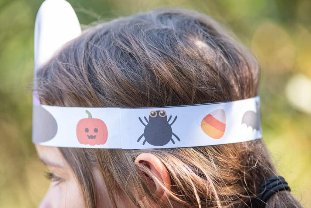 A side view of a child wearing a printable witch hat headband