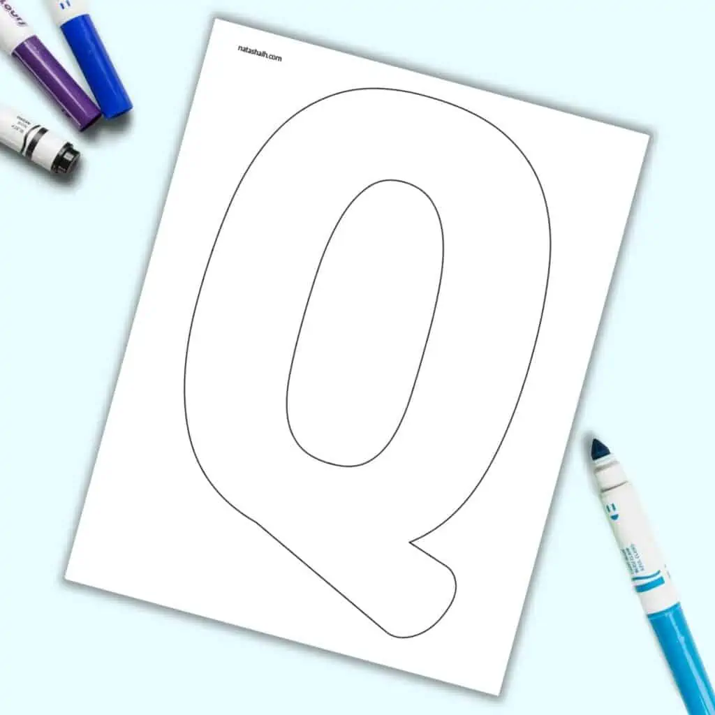 A page with a large bubble letter Q. It is shown on a light blue background with colorful children's markers.