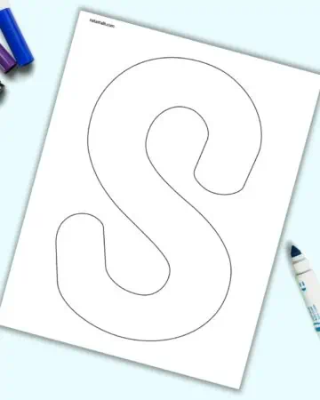 A page with a large bubble letter S. It is shown on a light blue background with colorful children's markers.