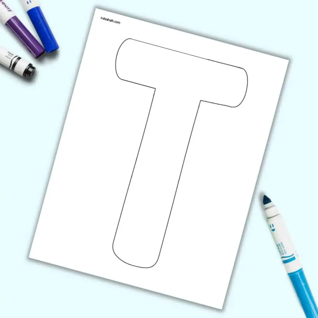 A page with a large bubble letter T. It is shown on a light blue background with colorful children's markers.