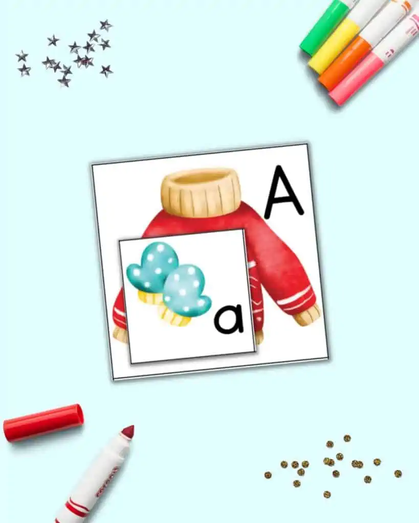 A pair of alphabet matching cards for the letter a. The uppercase has a sweater and the lowercase has a pair of mittens.