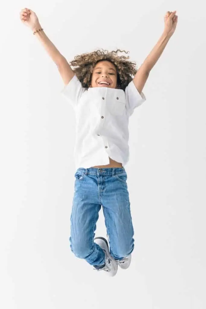 A boy jumping in the air with excitement