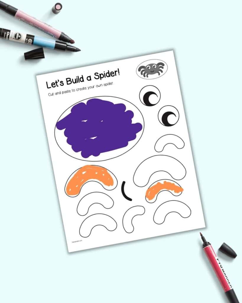 A preview of a partially colored orange and purple spider craft template to cut and paste