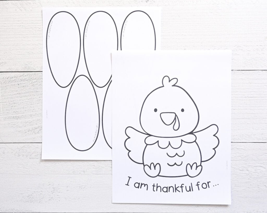 Two printed pages for a thankful turkey Thanksgiving craft. One page has a large cartoon turkey and the text "I am thankful for..." and the other page has five large tail feathers.