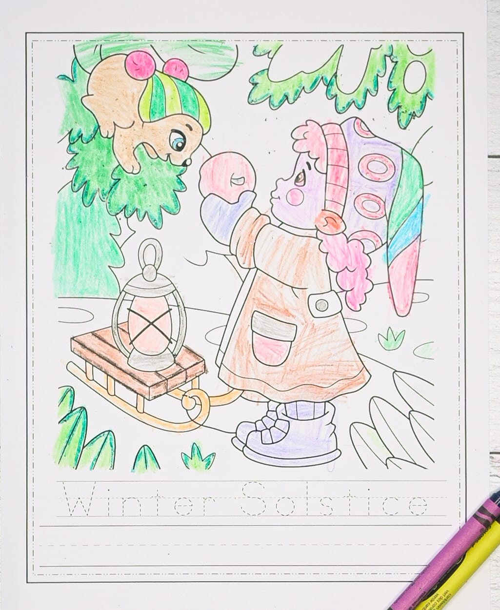 A colored in picture of a winter gnome girl standing above the words "Winter Solstice" in a dotted font to trace.