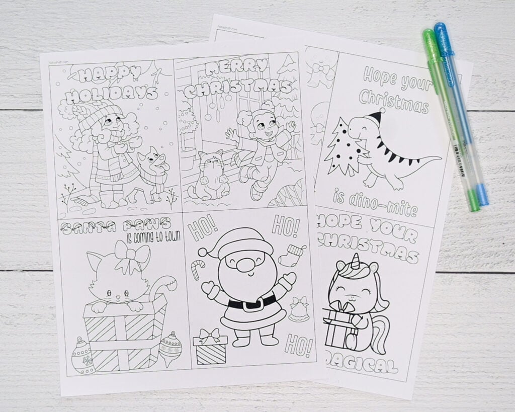 A top down photo of two pages of printable Christmas cards to color.
