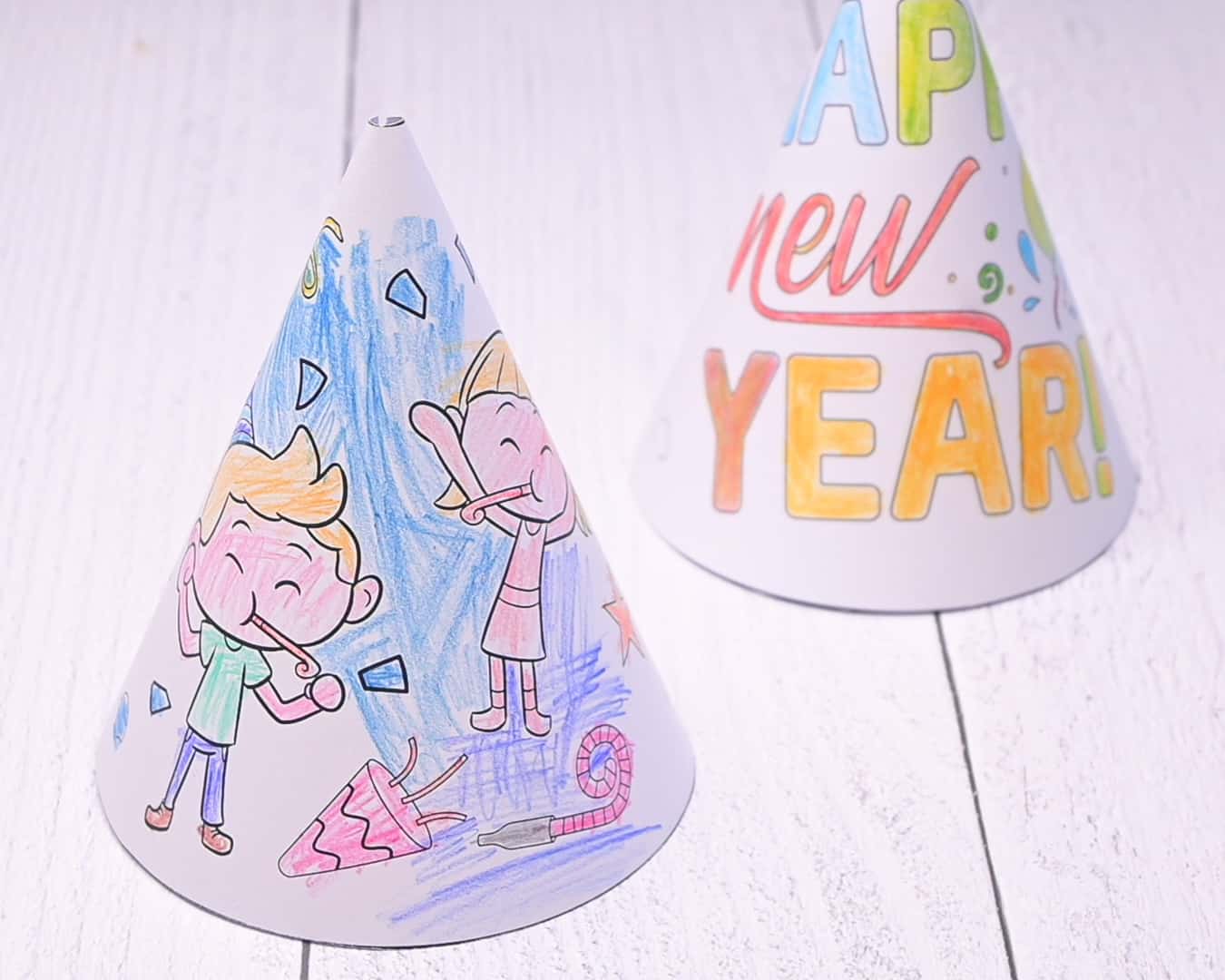 A picture of two colored and assembled printable New Year's party hats