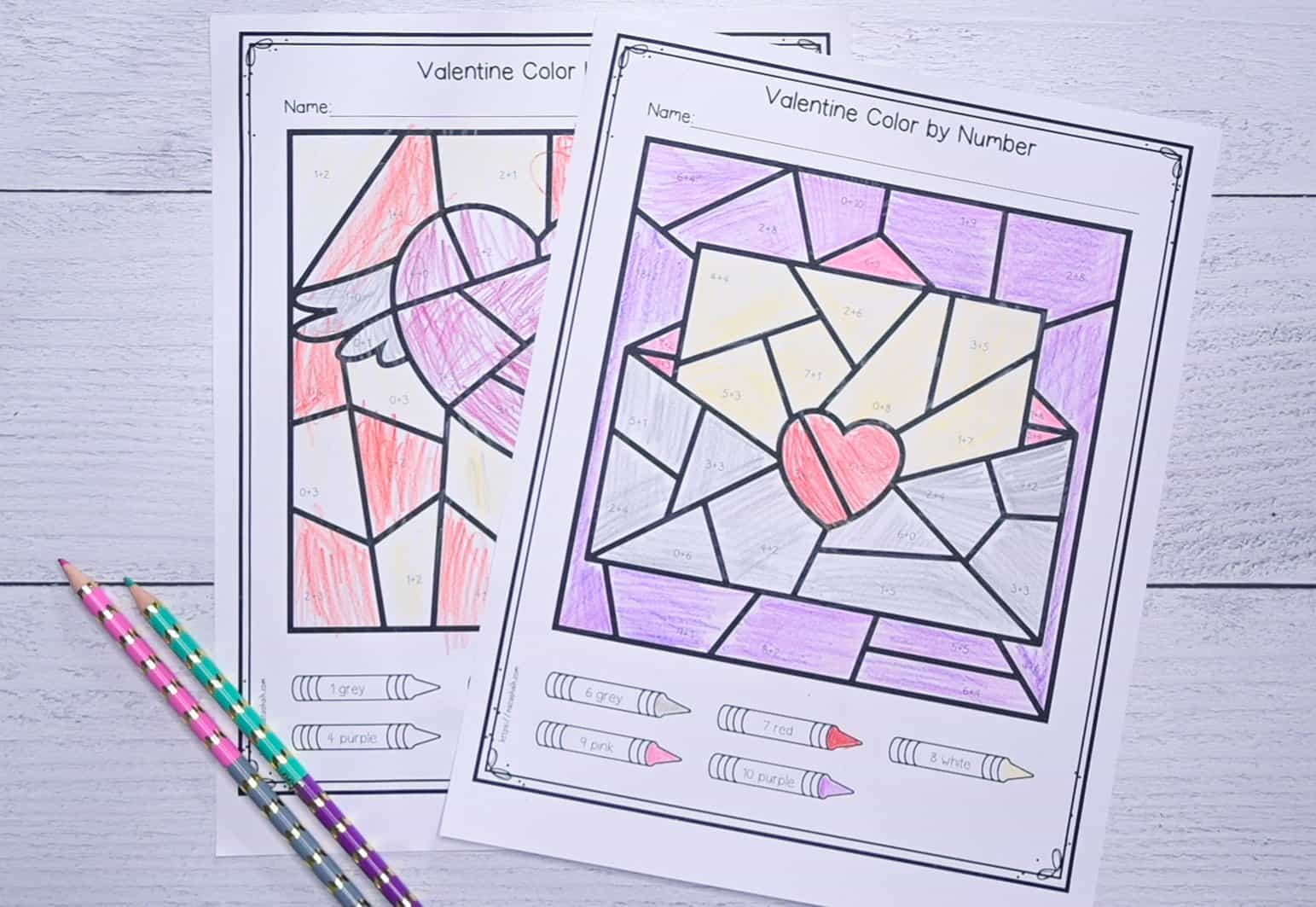 a photo of two completed Valentine's Day themed color by addition pages with addition facts 1-10