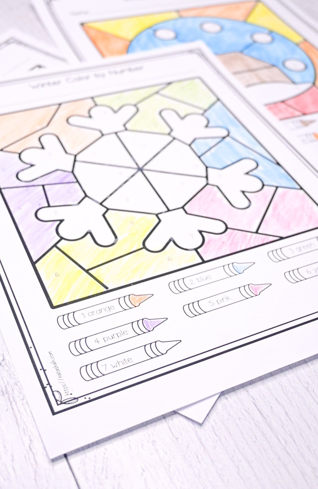 A picture of a completed color by number worksheet with a snowflake