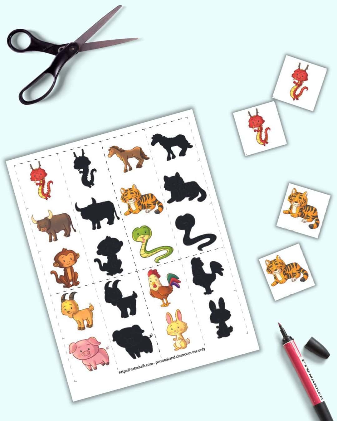 A page of un-cut out shadow machine cards with Chinese zodiac animals and two pairs of cards  with tigers and dragons