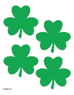 A preview of four medium shamrock printable templates in green