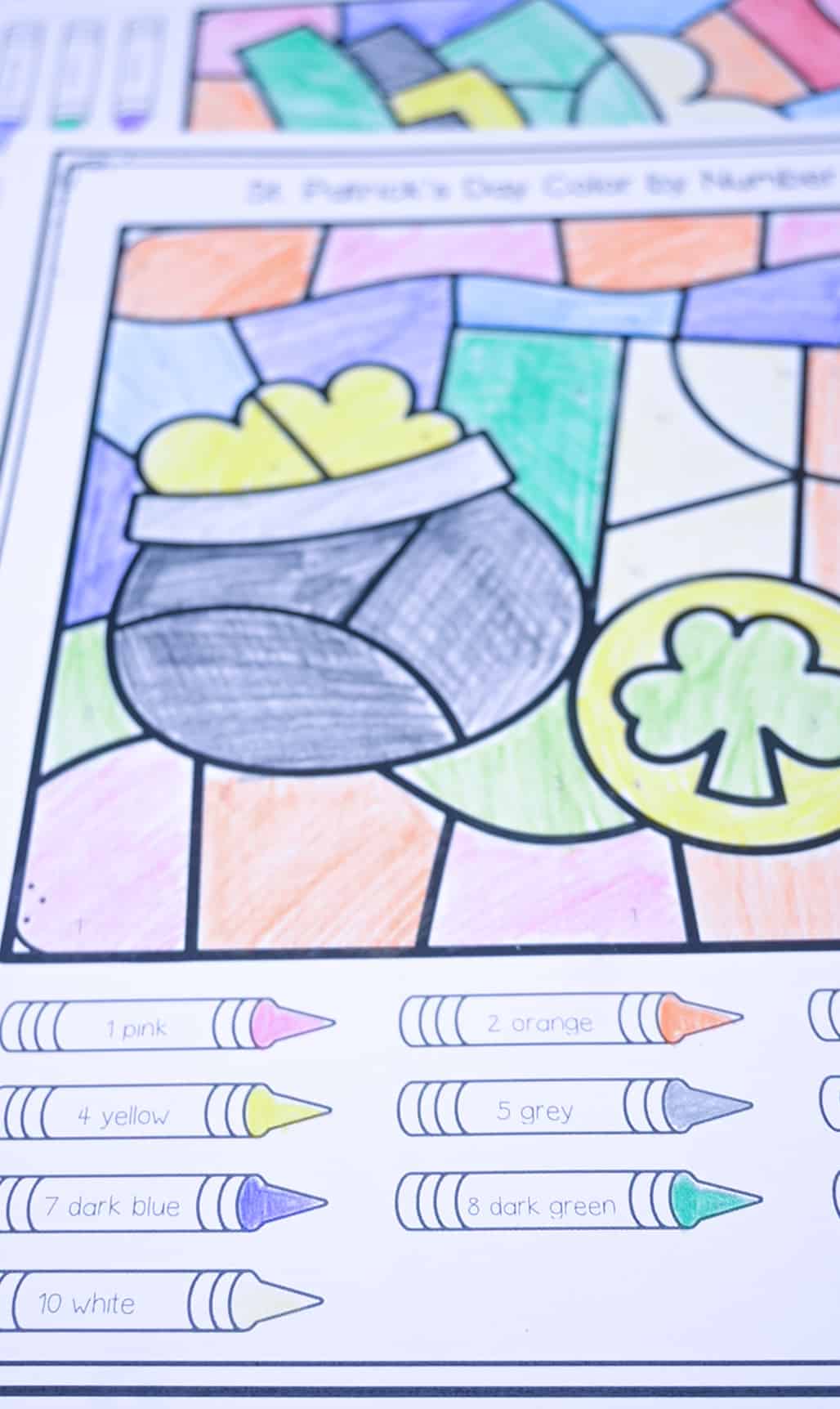 a photo of crayons colored on a St. Patrick's Day color by number page to create a key for children