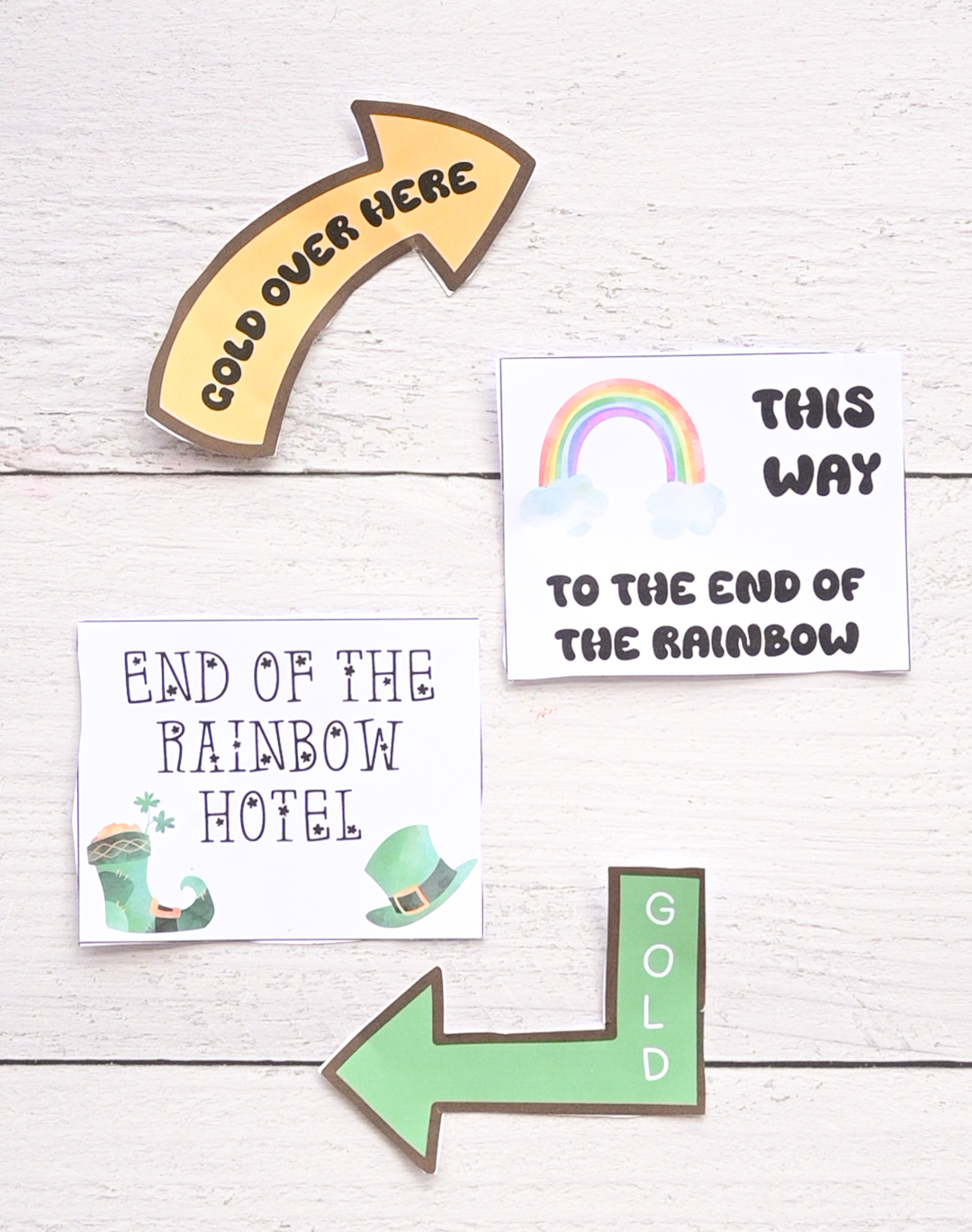 A top down photo of four printable signs for a leprechaun trap.