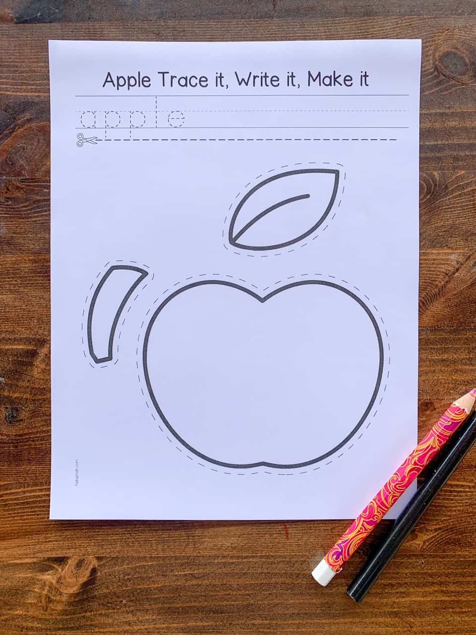 a top down photo of a black and white cut and paste apple craft page