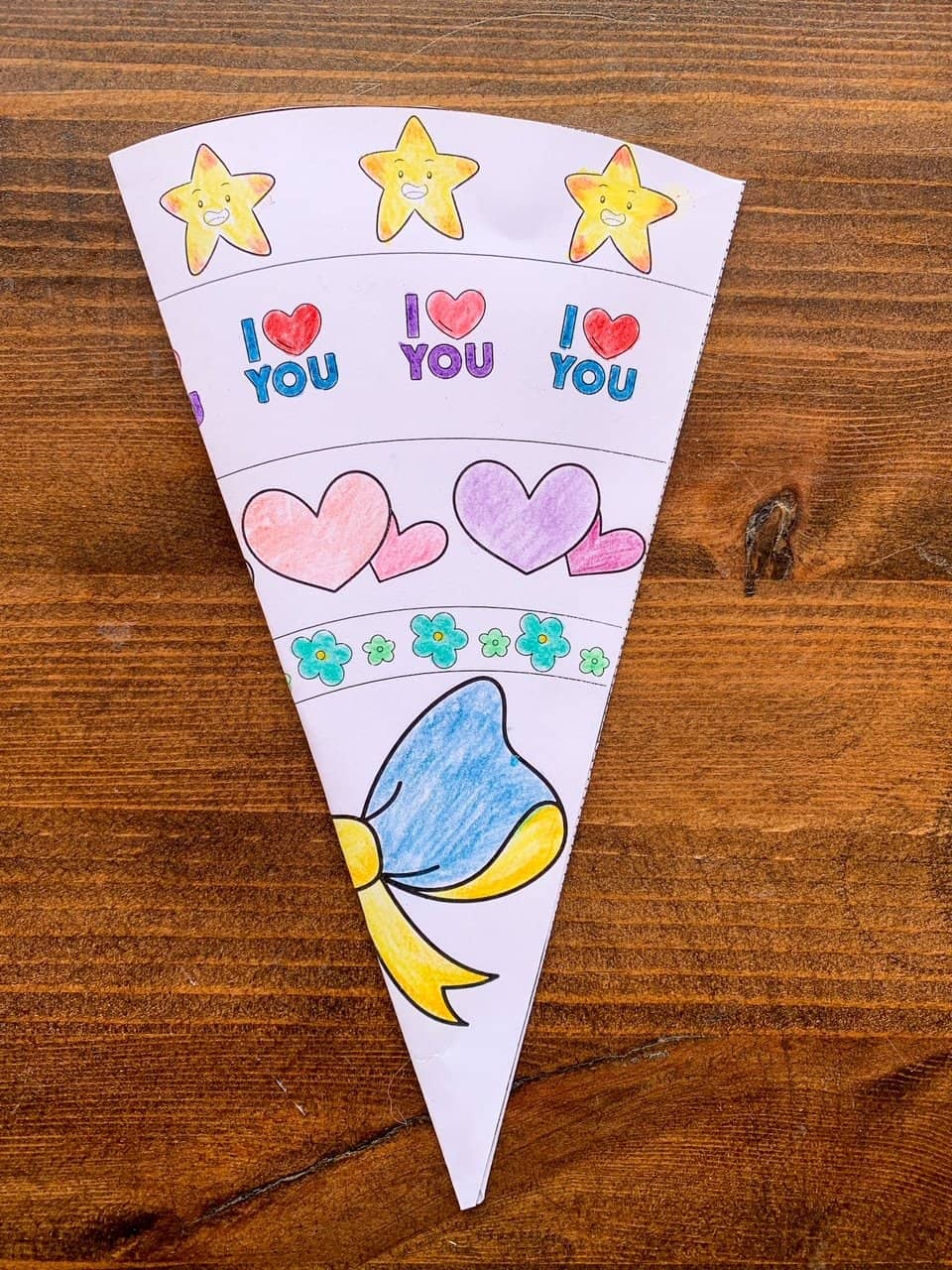 A colored and completed paper bouquet card wrapper