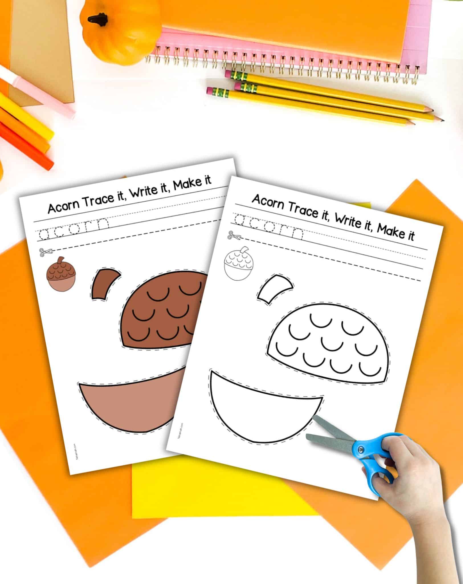 Two pages of cut and paste acorn template. One is in color and the other in black and white. They are on a desk with fall colored school supplies and a child's hand holding open scissors.