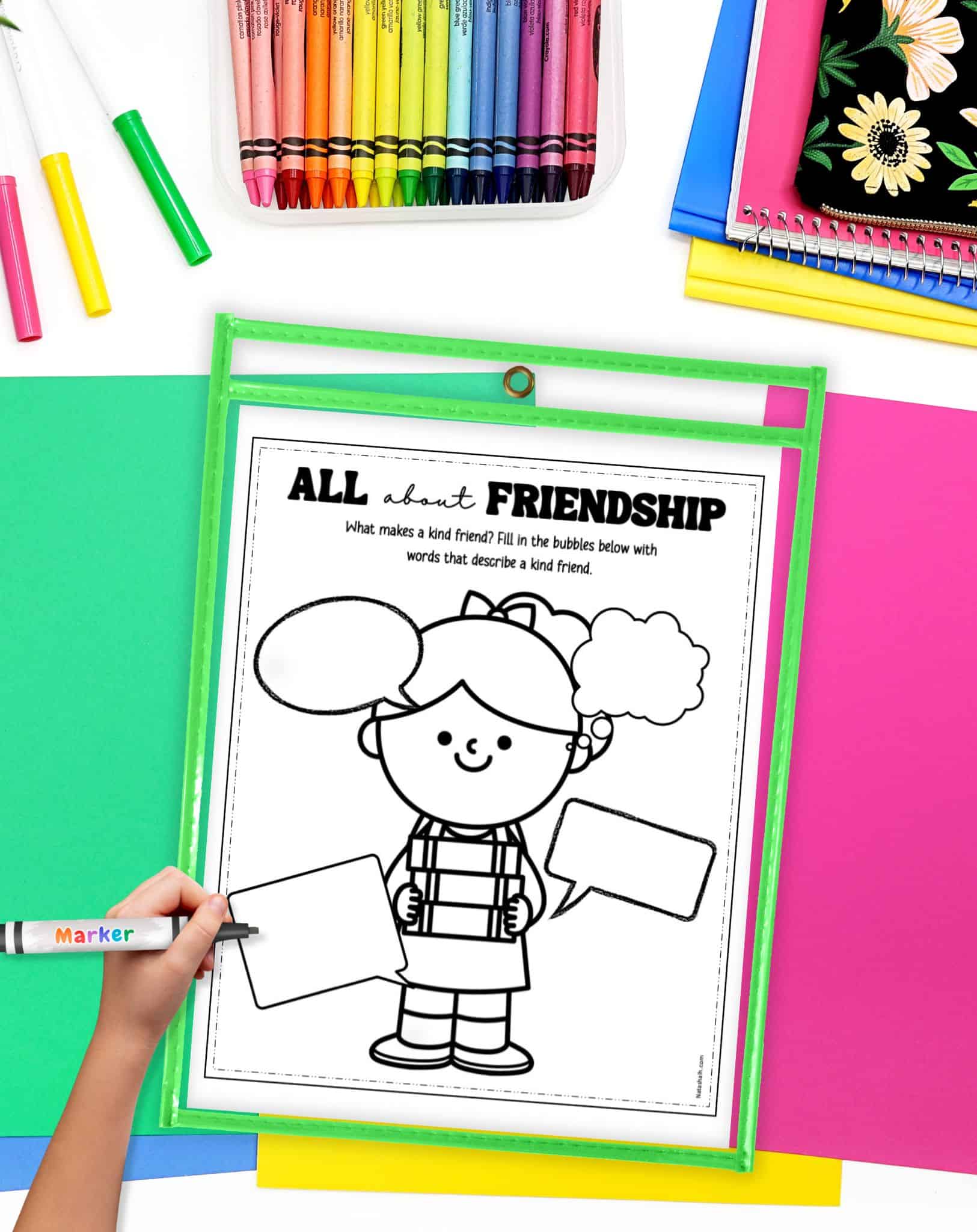 an "all about friendship" worksheet in a dry erase pocket on a desk with colorful papers