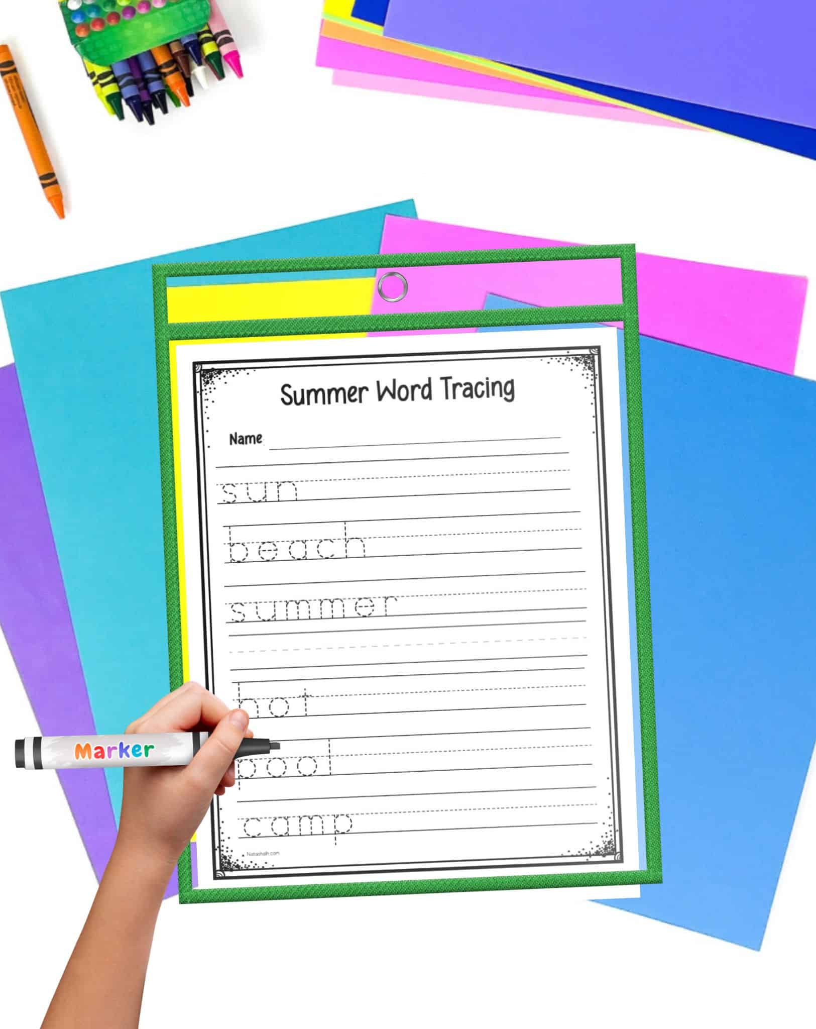Colorful student desk supplies with a summer word tracing worksheet in a green dry erase pocket