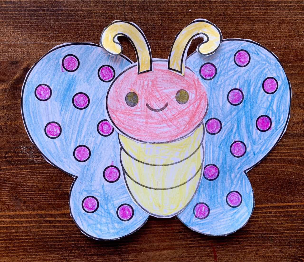 A photo of a completed cut and paste butterfly craft colored by a child.