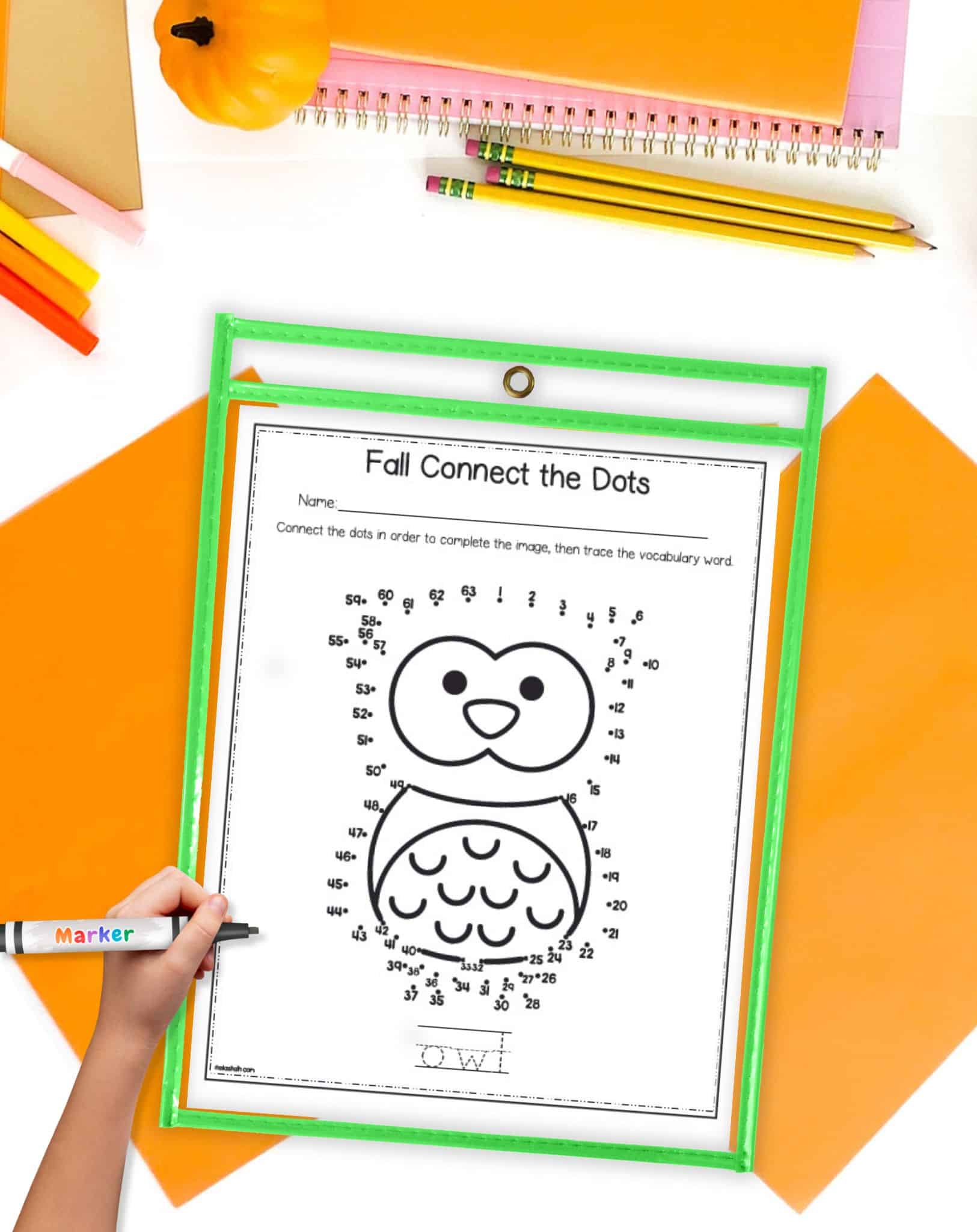 An owl connect the dots page in a page protector on a desk with fall colored school supplies