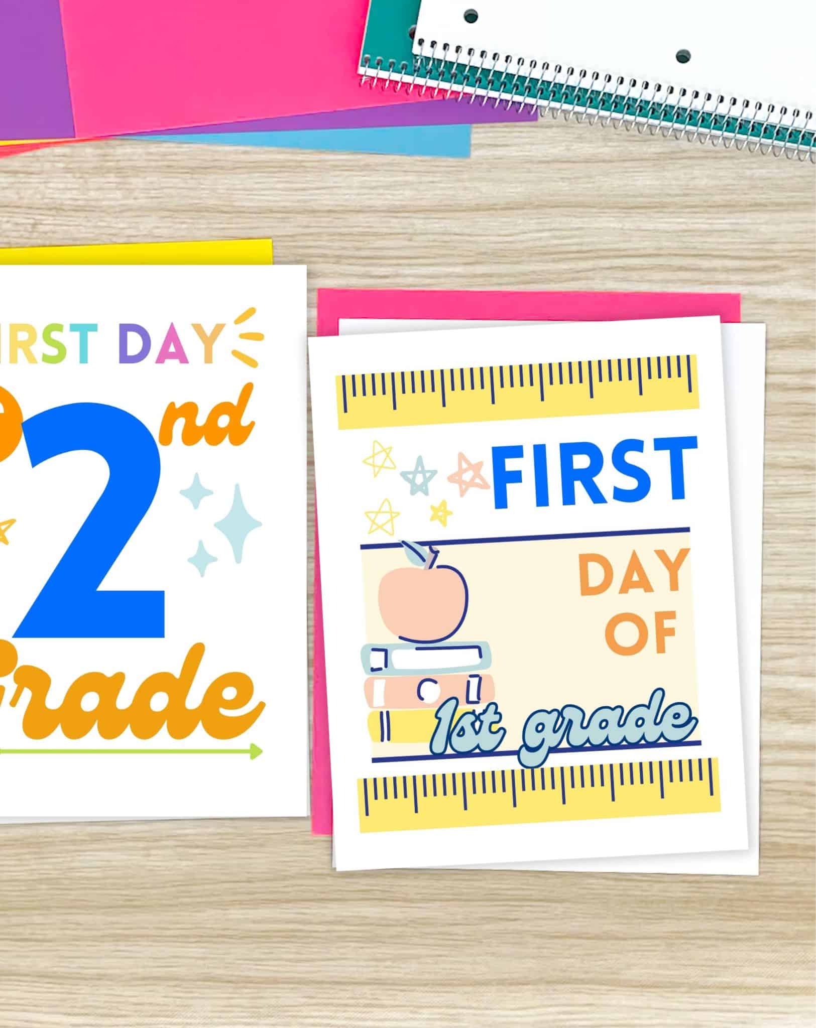 Two first day of school signs on a wooden desk with notebooks