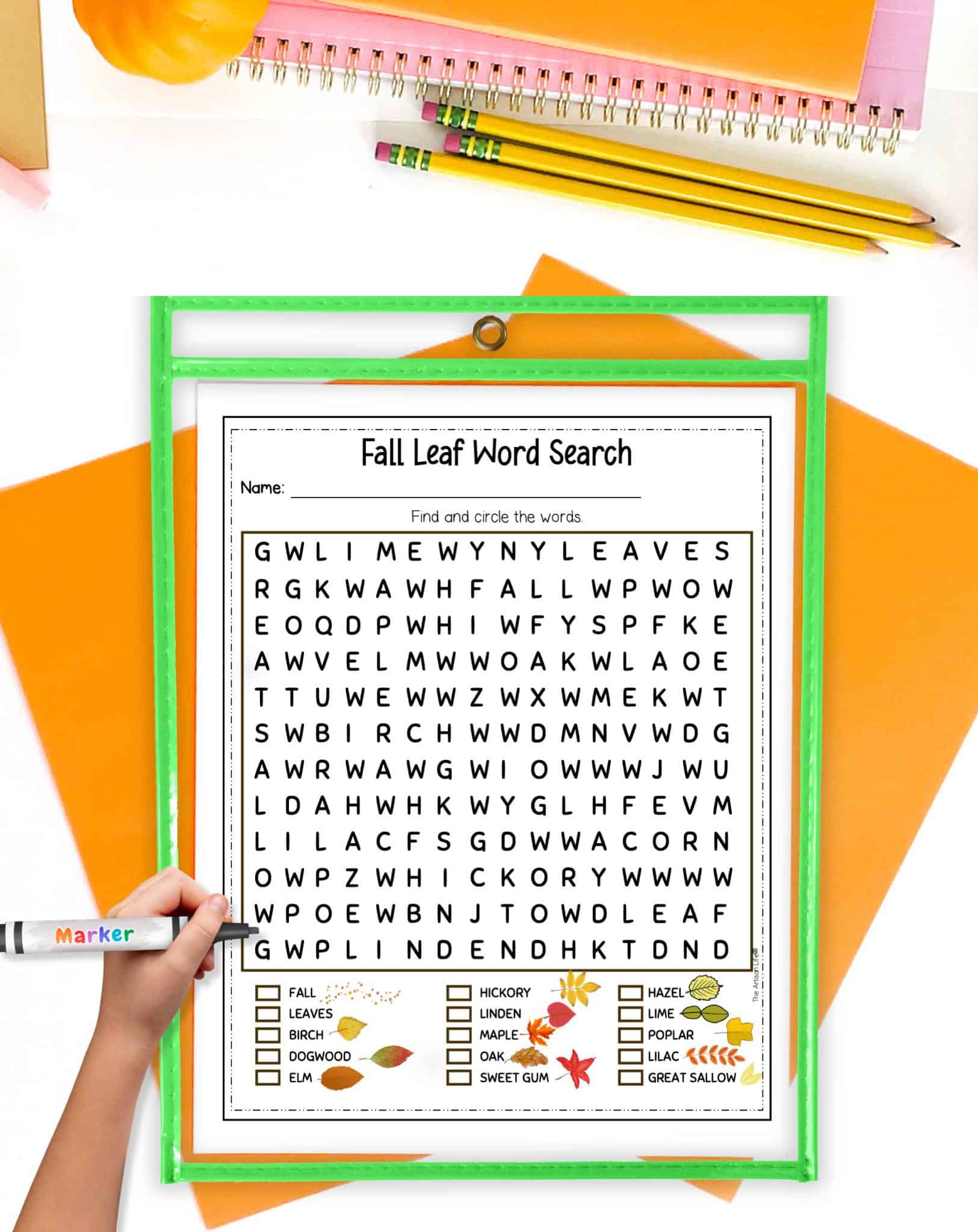 A fall leaf word search in a dry erase pocket. The dry erase pocket is on a table with orange papers.