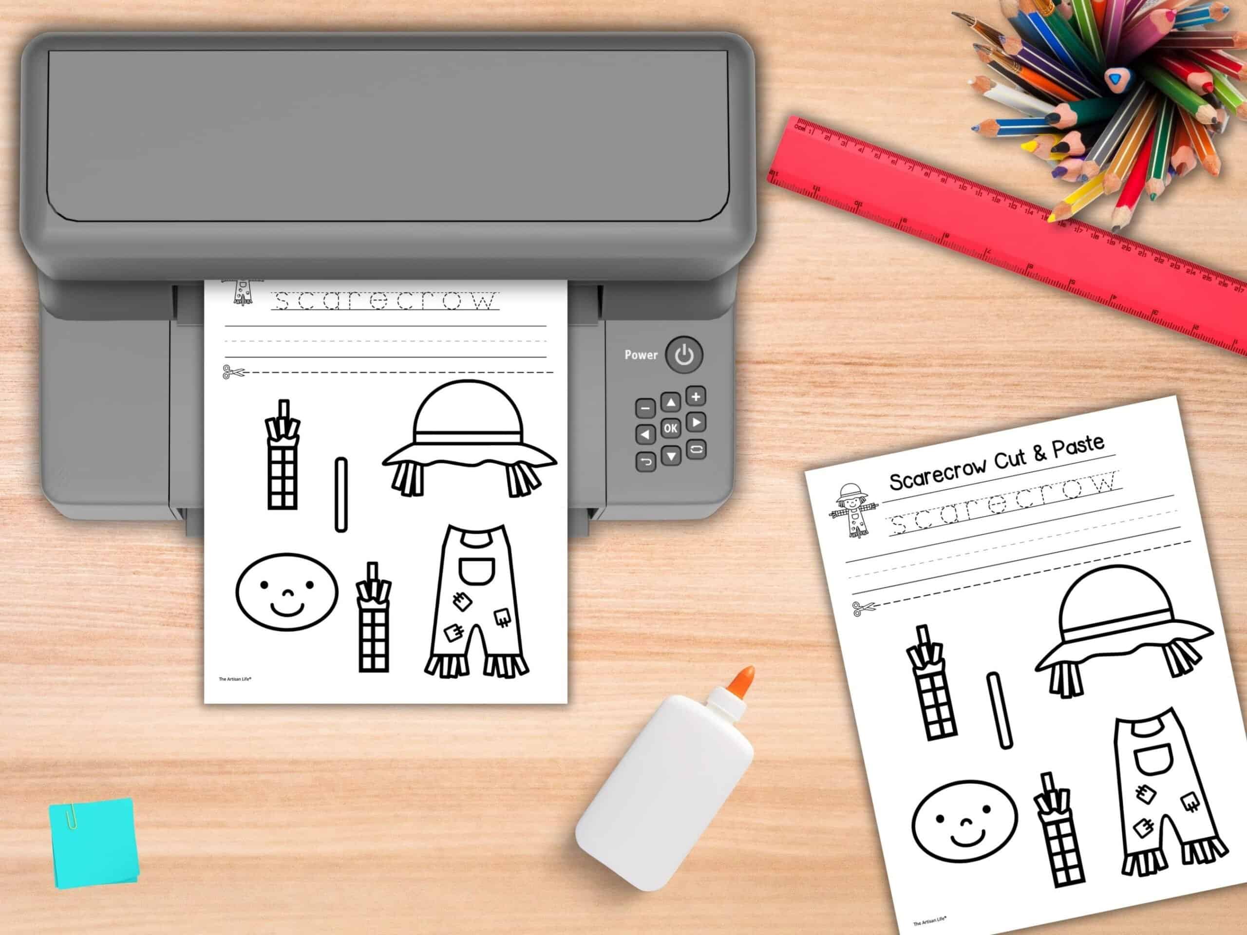 A mockup of a printer printing a scarecrow cut and paste craft for kids