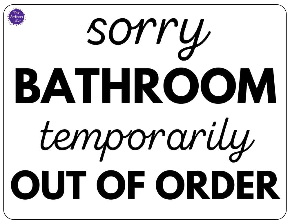 Black sign with cursive script reading sorry bathroom temporarily out of order