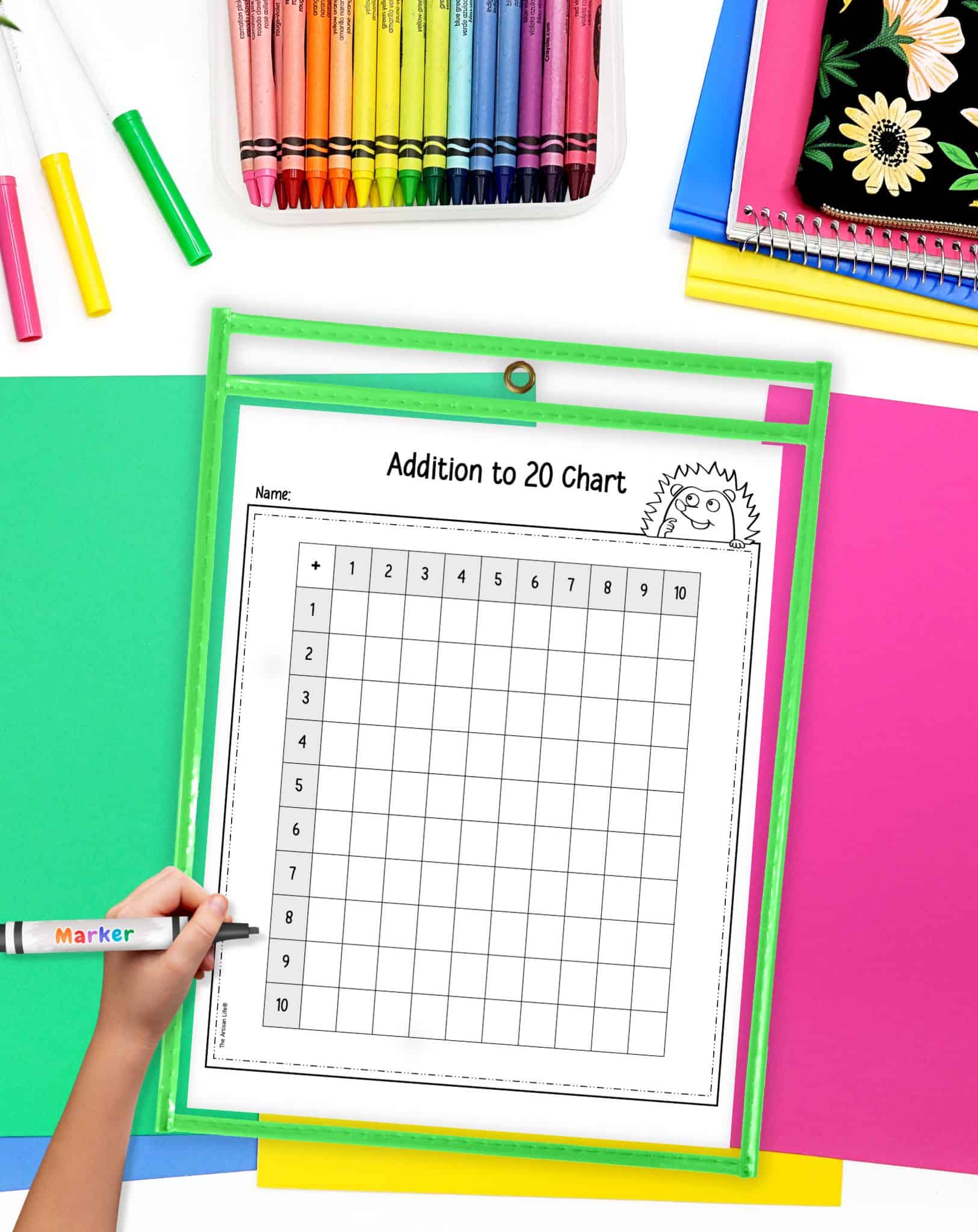 A blank addition to 20 chart in a dry erase pocket. A child's hand holding a dry erase marker is visible in the foreground.