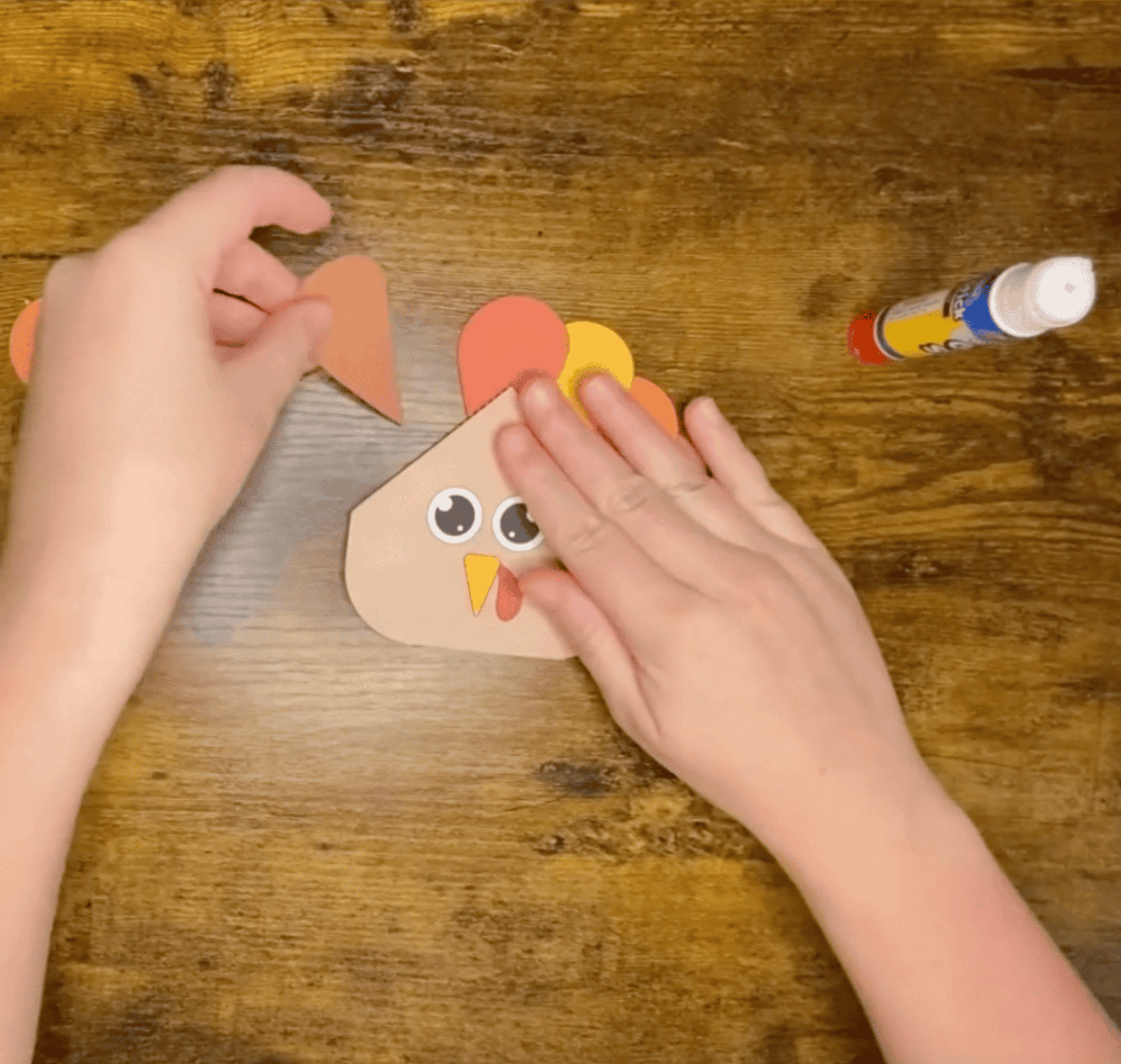 Gluing tail feathers to a turkey bookmark craft