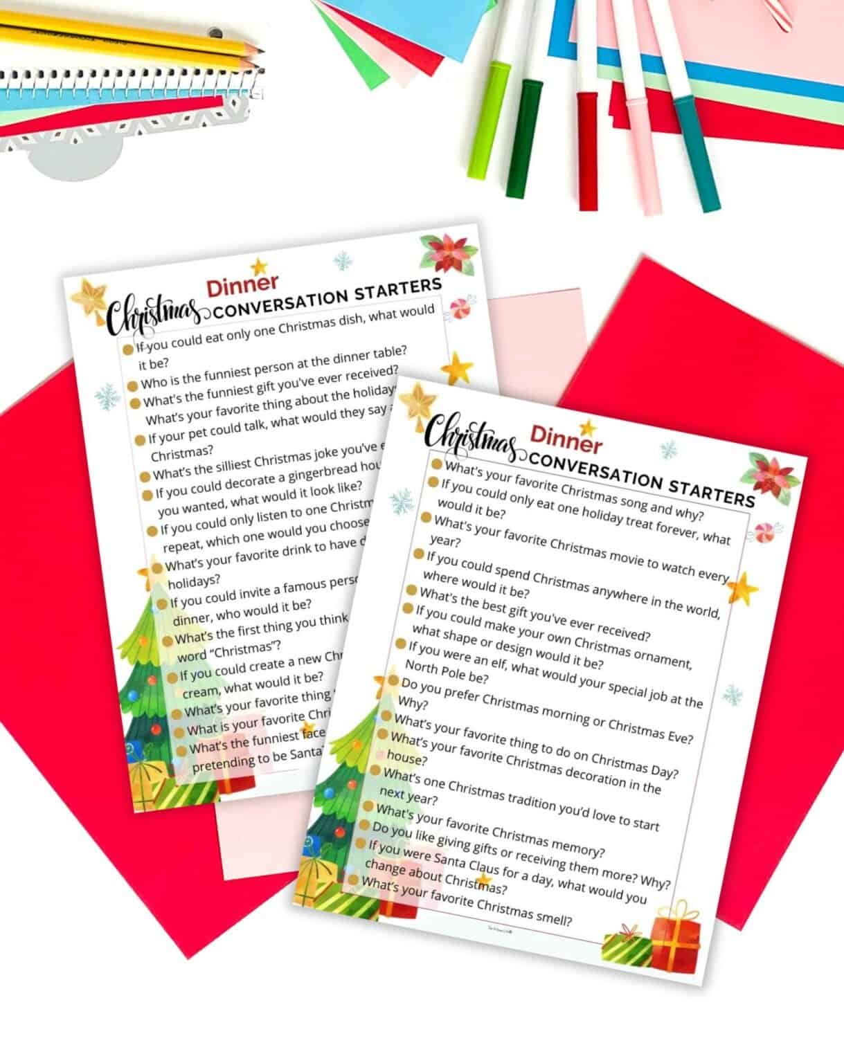 Two pages of Christmas dinner conversation starter print outs on table with Christmas stationery