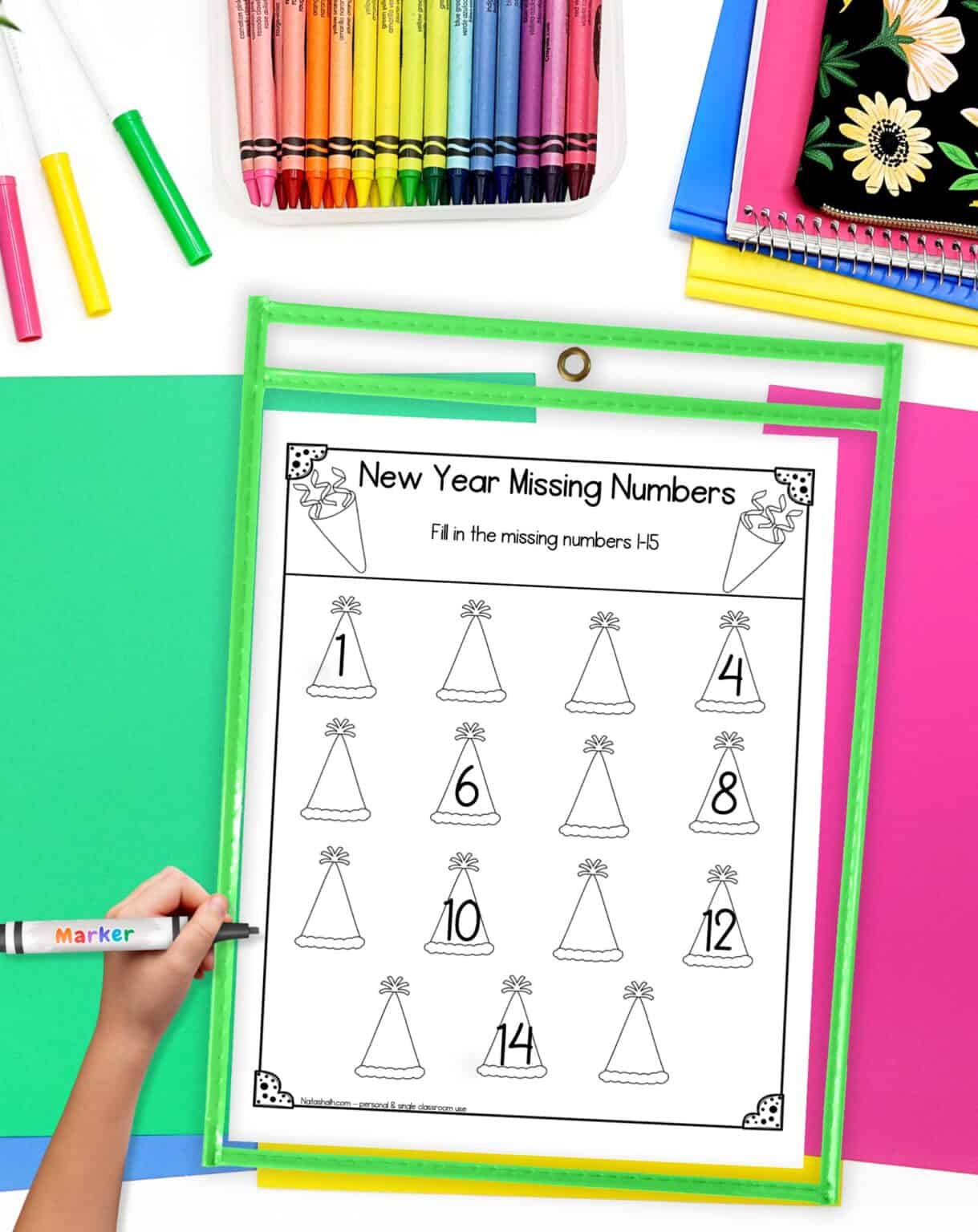 a new year themed missing number worksheet 1-15 in a dry erase pocket on a desk