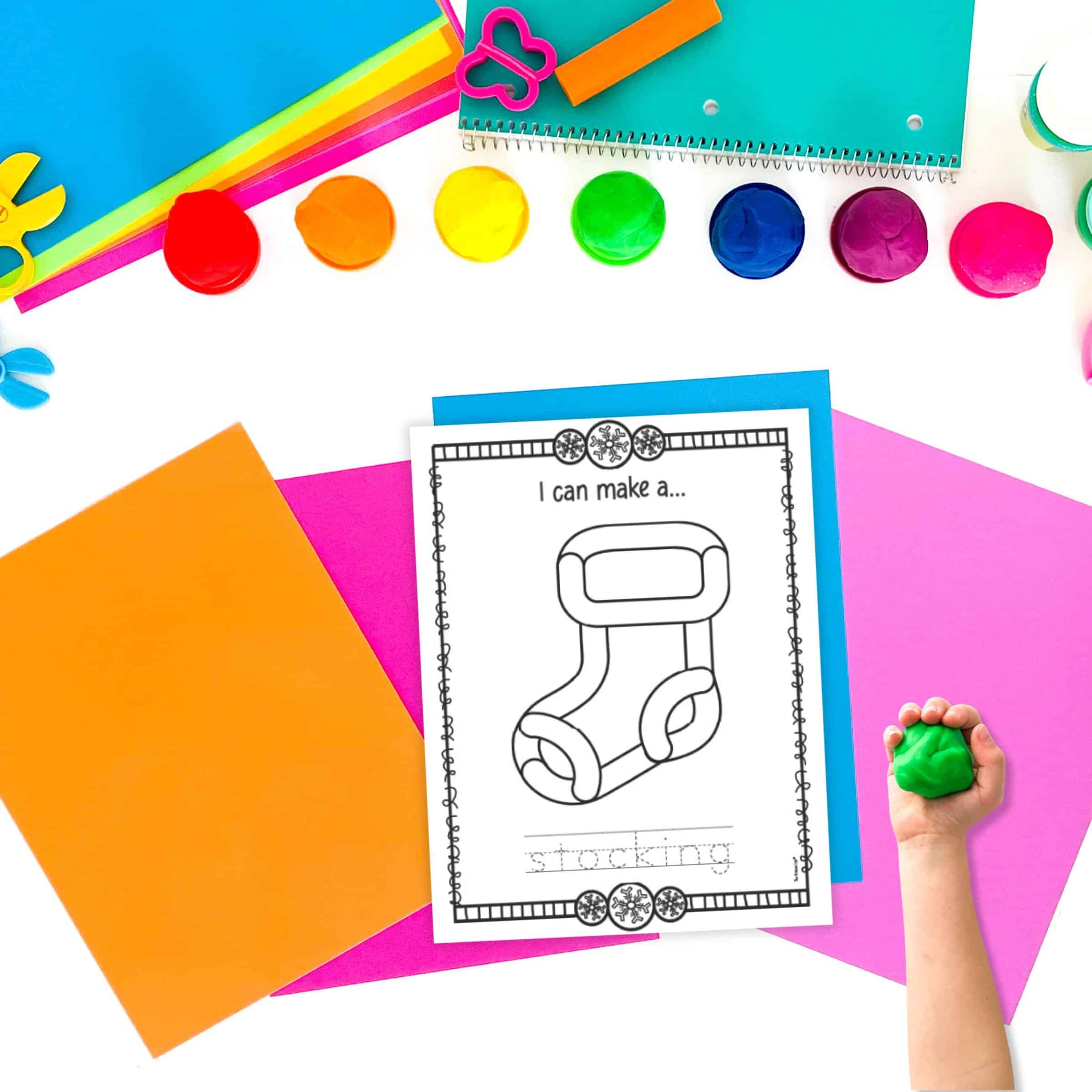 a stocking play dough mat with a child's hand holding a ball of green play dough