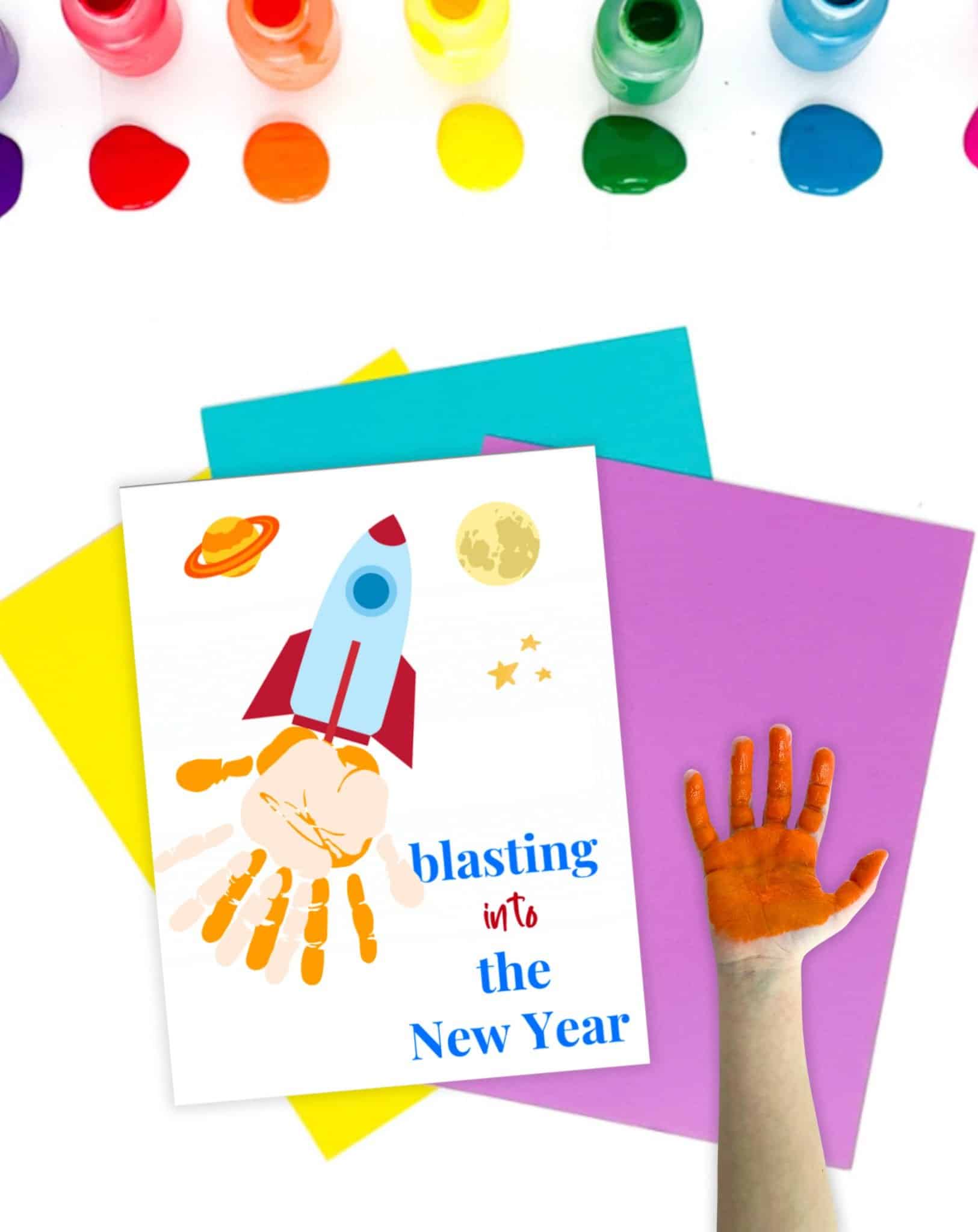 a handprint craft page reading "blasting into the new year" with a child's hand covered in red paint