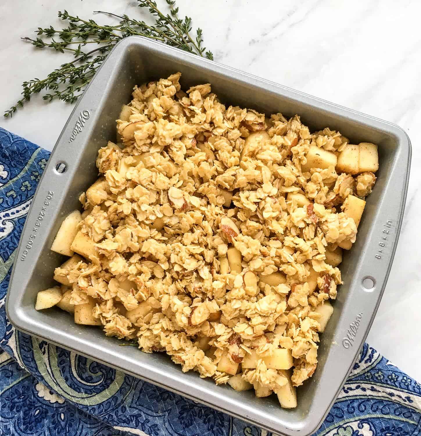 apple crisp in a pan ready to go in the oven