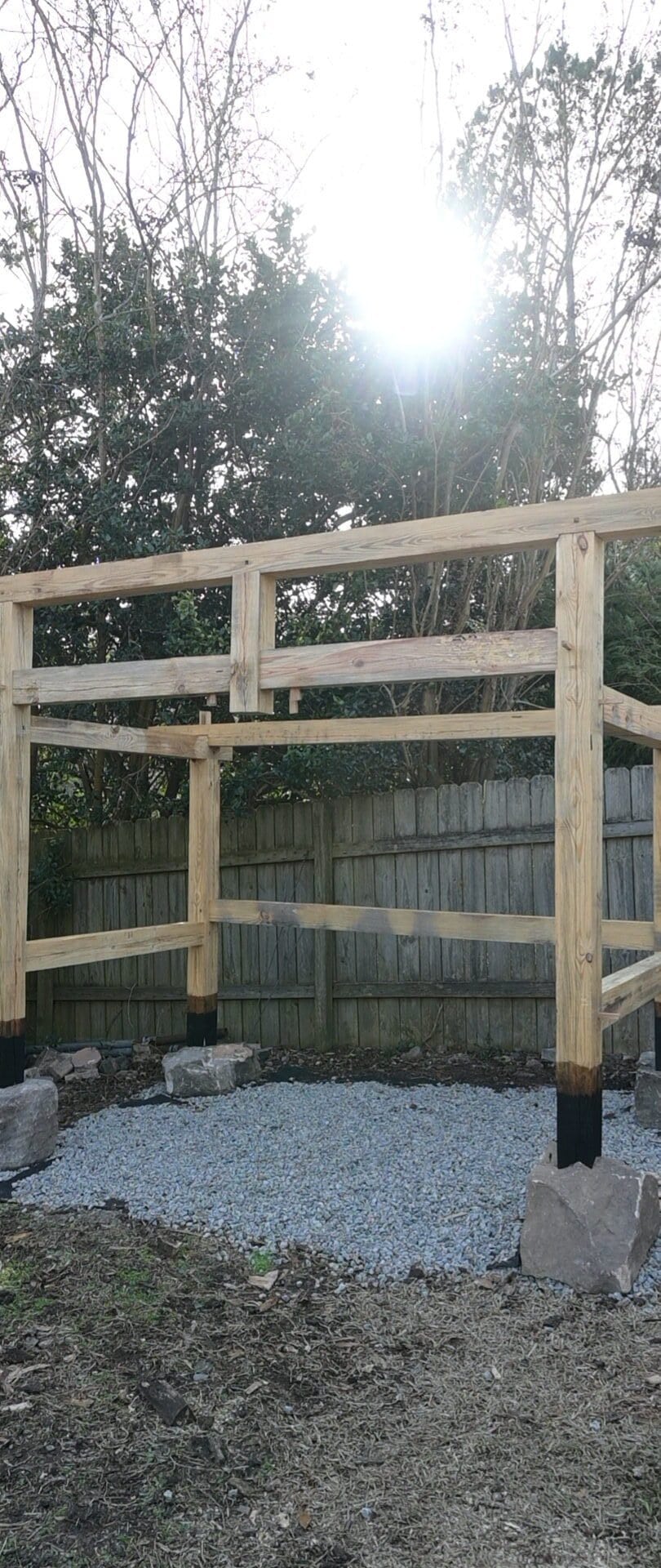 a timber frame woodshed that is scribed to stone