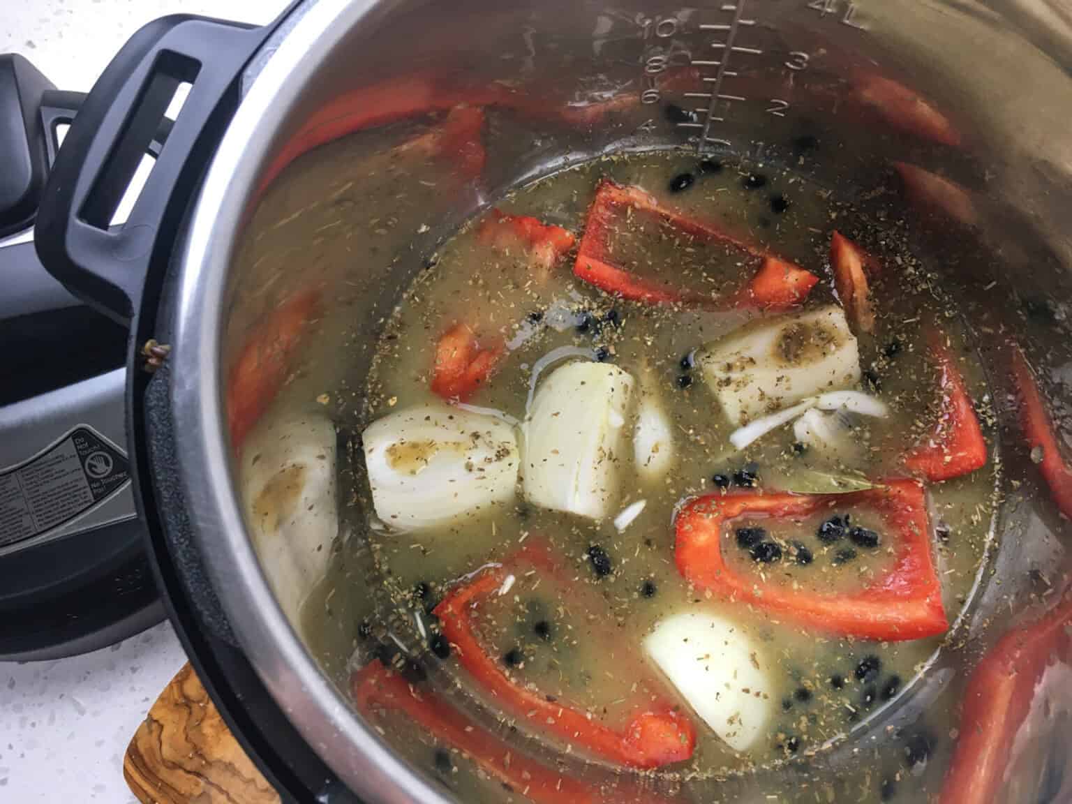 onion, red pepper, black beans, seasoning, and broth in an Instant Pot