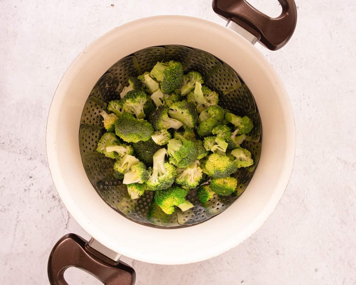 a steamer basket in a pot for steaming broccoli 