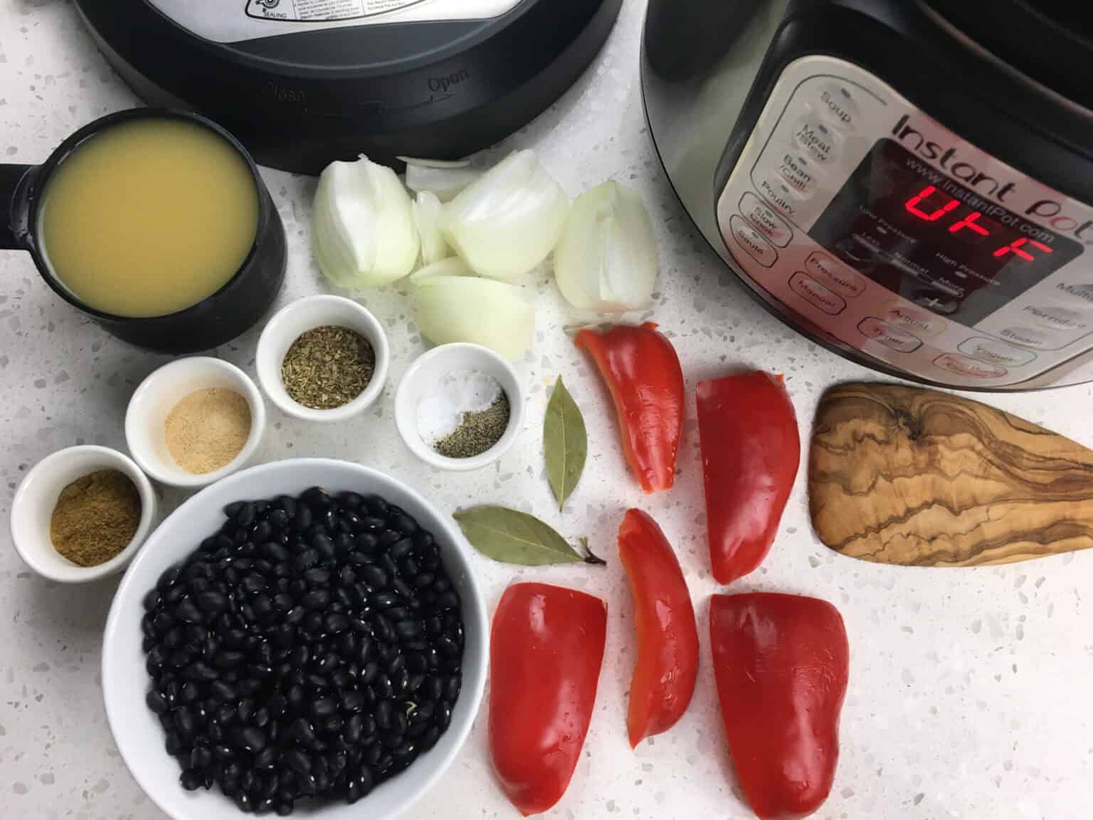 ingredients for Instant Pot Cuban style black beans including black beans, broth, red pepper, and onion
