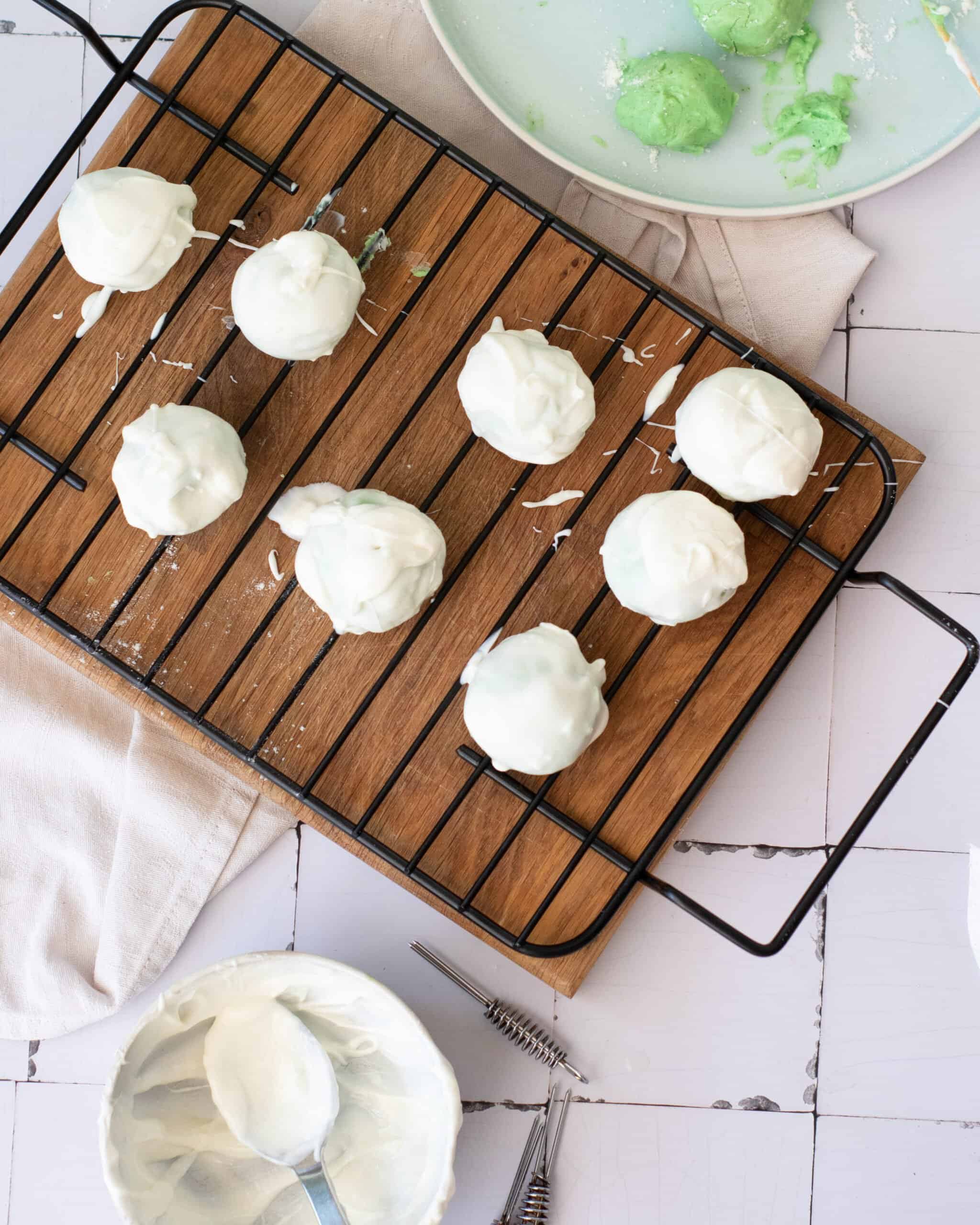 white chocolate coated no bake truffles on a wire rack