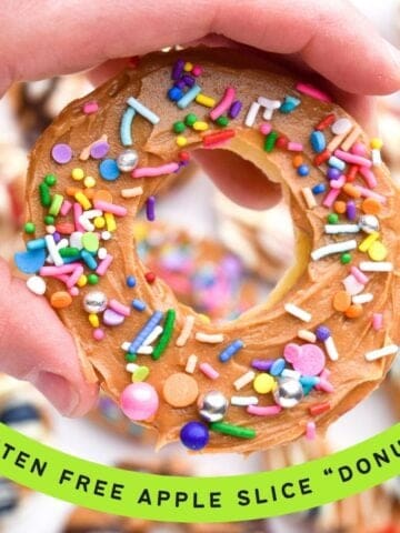 a hand holding an apple slice with peanut butter and sprinkles and a text overlay "gluten free apple slice donuts"