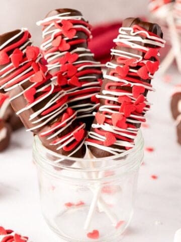 a jar with three Valentine's Day marshmallow pops