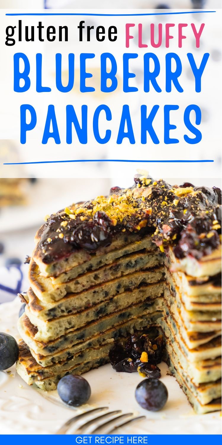 A stack of gluten-free blueberry pancakes topped with blueberry sauce and garnished with crushed nuts is displayed on a white plate, emphasizing a homemade breakfast option.