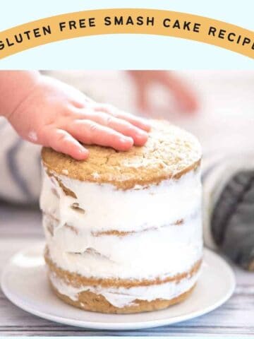 a toddler's hand on top of a small layer cake with the caption "gluten free smash cake recipe"