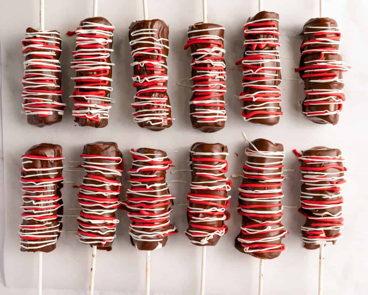 marshmallow pops with red and white drizzle 