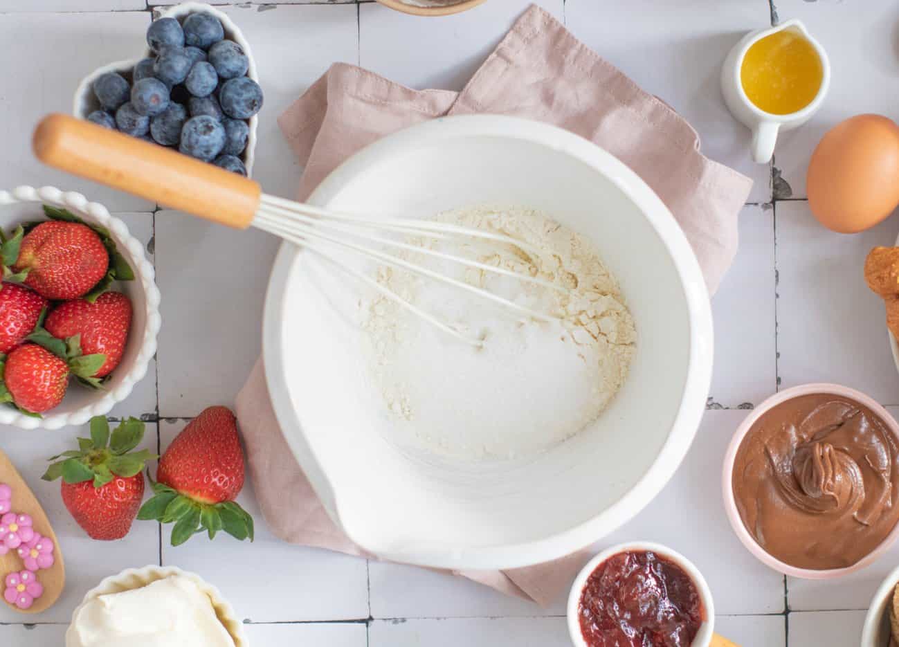 A top down image of mixing flower and baking soda to make waffles