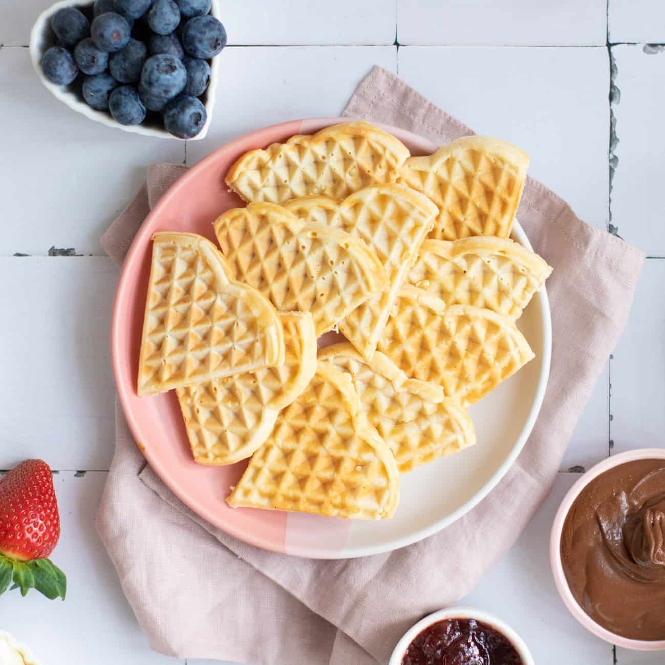 a top down photo of heart shaped waffles on a plate