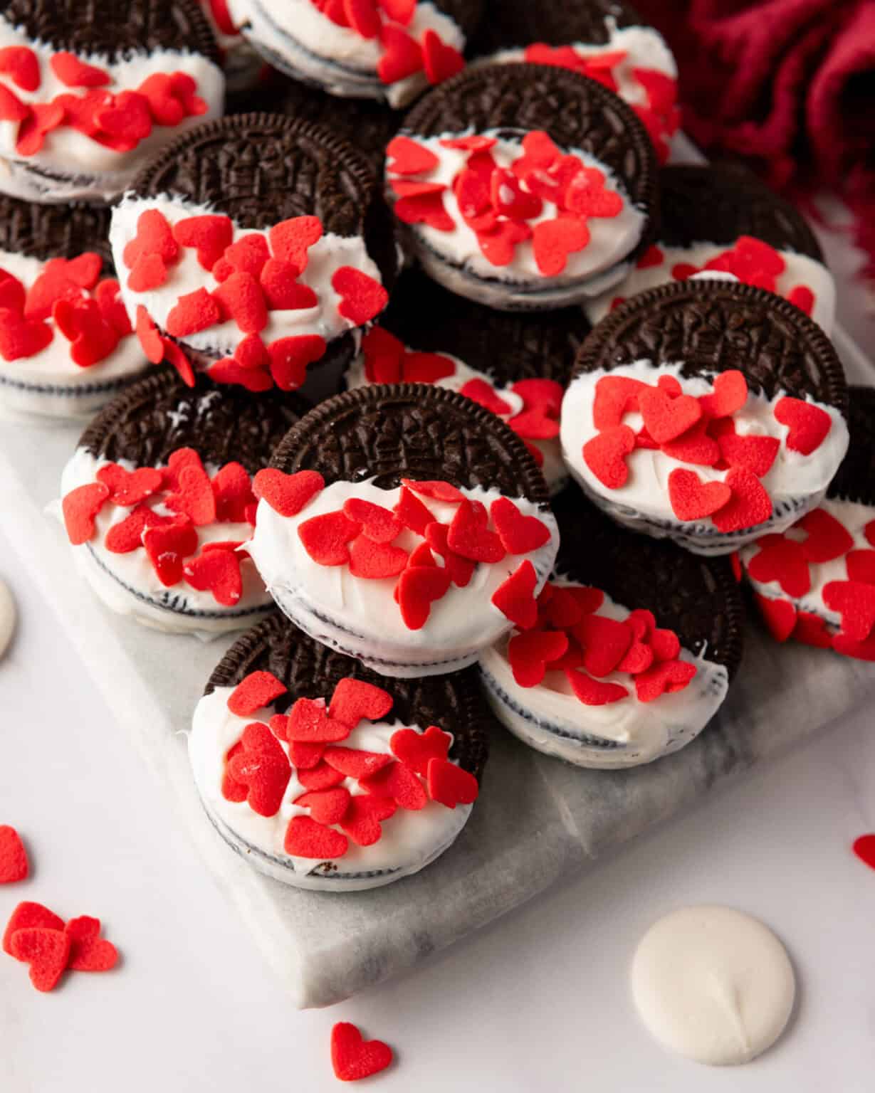white chocolate dipped Oreo cookies on a marble serving board