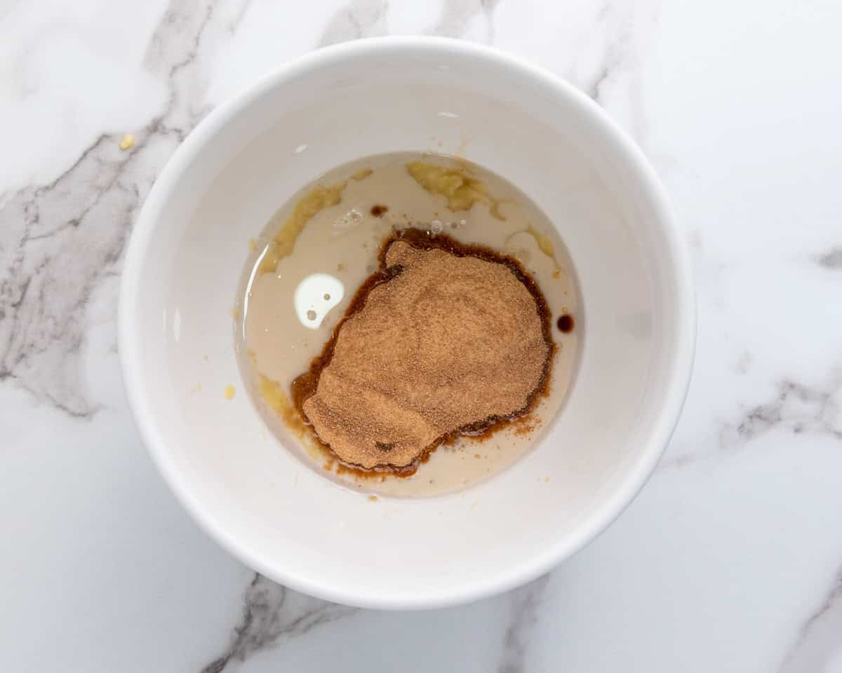 coconut sugar, milk and vanilla added to a bowl of mashed bananas