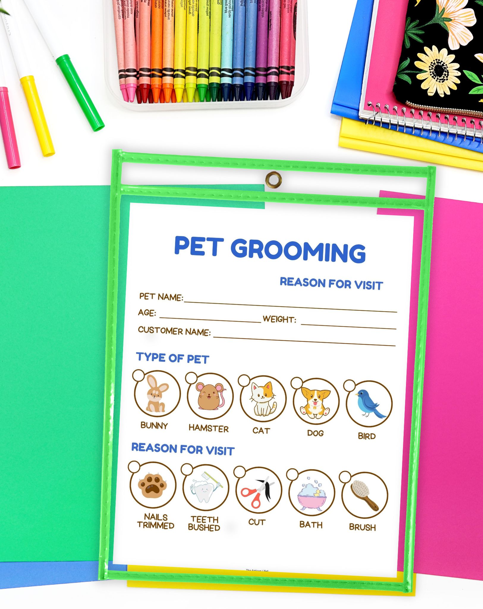 A colorful printable sheet titled "Pet Grooming" outlines sections for pet name, age, weight, customer name, type of pet, and reasons for visit, surrounded by various colored craft supplies on a bright background.
